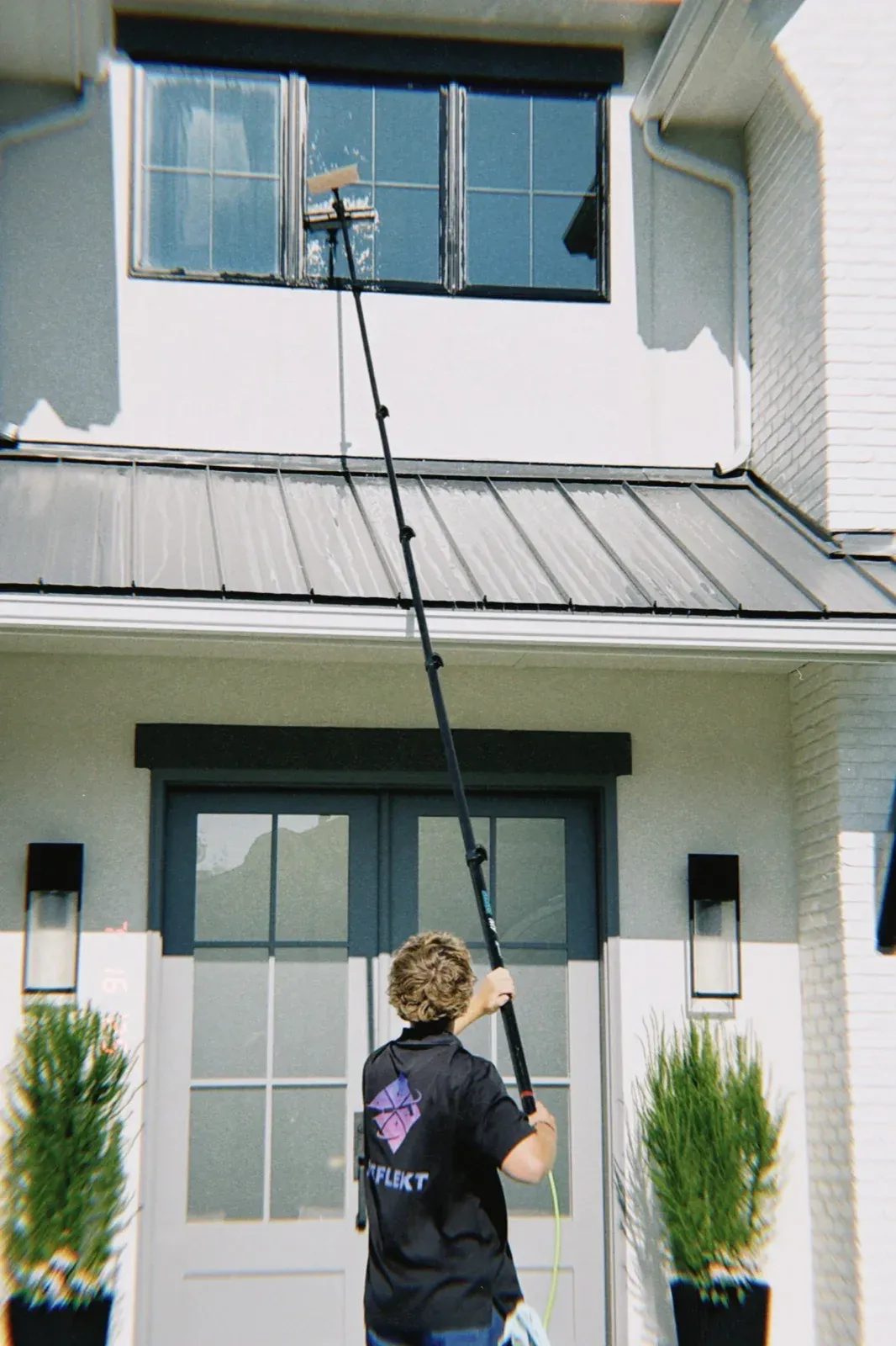 Cleaning a second-story window with a water-fed pole in Boise, Idaho