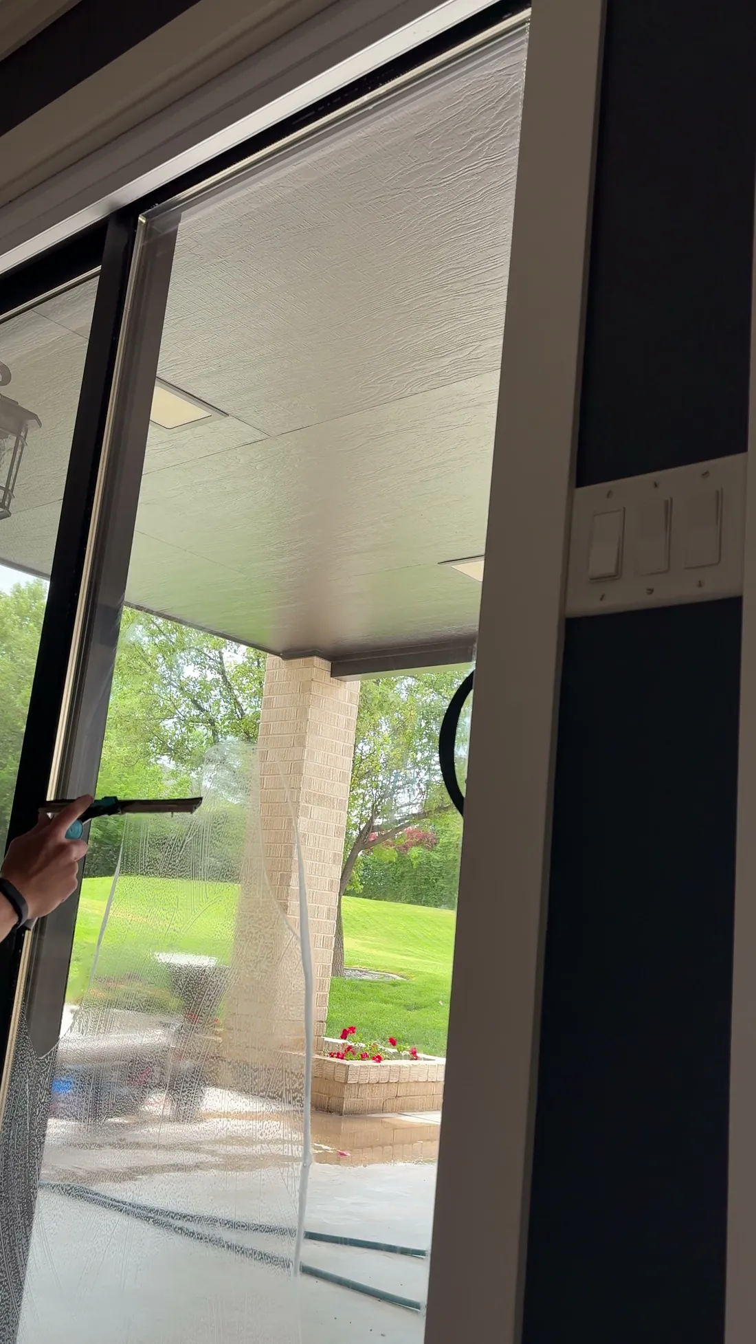 Reflekt crew squeegeeing a glass patio door in the Treasure Valley, Idaho
