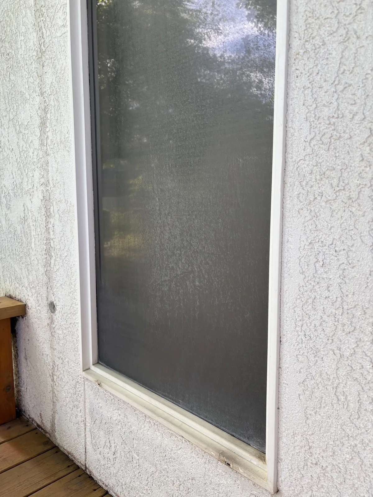 Window with cloudy hard water stains before Reflekt removal in Boise, Idaho