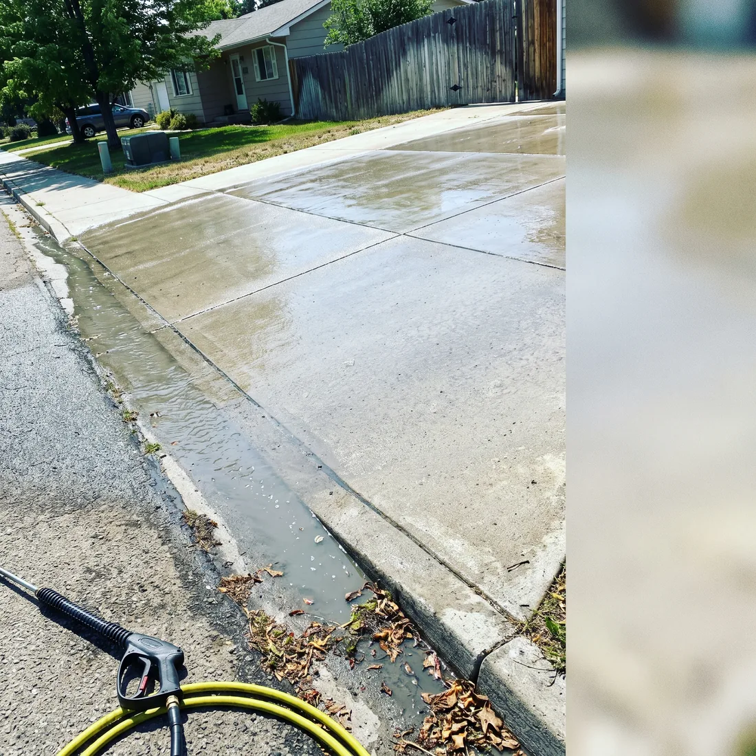 A freshly pressure-washed Treasure Valley driveway being rinsed clean and clear