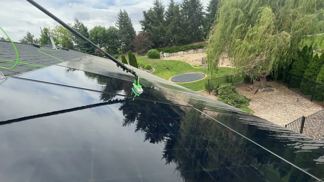 Reflekt crew rinsing solar panels spot-free with deionized water in Boise, Idaho