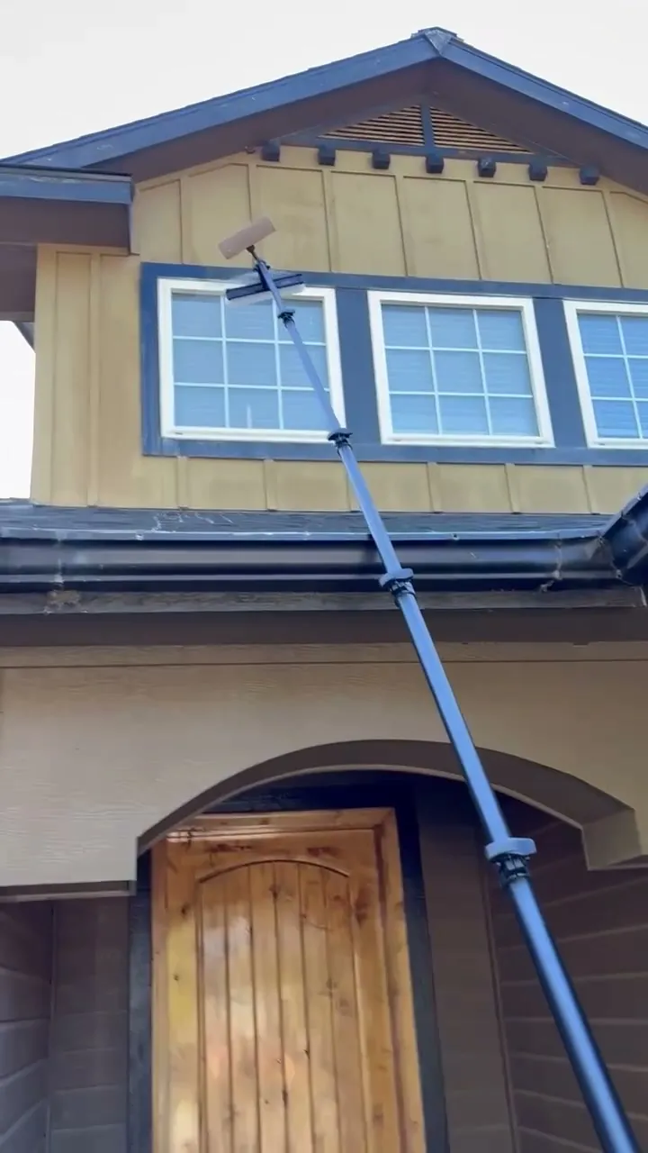 Reflekt crew cleaning second-story windows with a water-fed pole in the Treasure Valley, Idaho